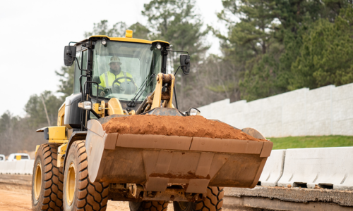 A loader operator load a sand in a loader bucket