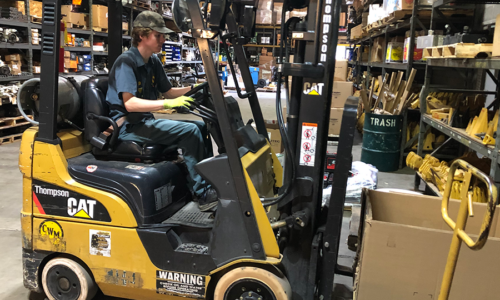 Man operating forklift in a warehouse